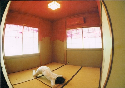 The wall doens red from the top halfway. The body is lying face down.