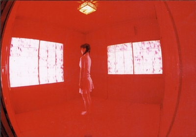 Stands upright in the middle of a red room. The lights also shine red.