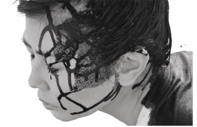 Close-up of the left face: Lines of paint run across it.