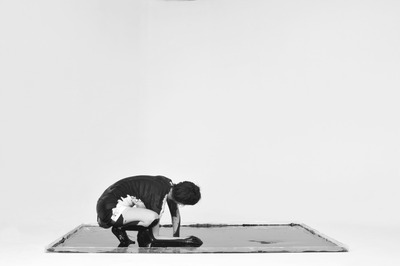 Squatting pose: A C is written in space