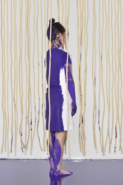 Standing pose. Purple vertical lines and paint scattered on the rope.