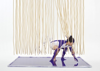 Squatting pose. Paint is being drawn on the rope.