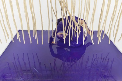 Close-up. Crouching in the purple pool. The back is dyed purple.