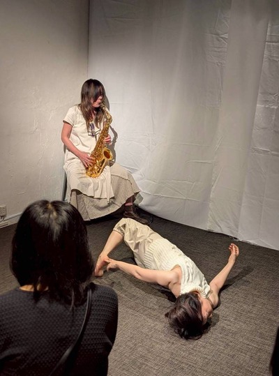 Lying down, the body twists; knees lift and the arms open